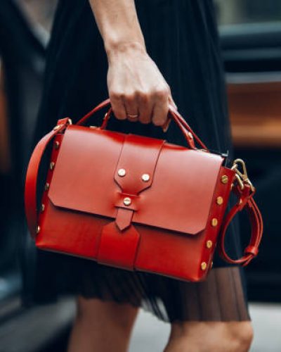 Women is holding handbag near luxury car Women is holding handbag near luxury car